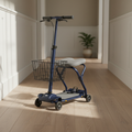 Navy blue knee walker scooter with padded gray knee rest and front basket parked on pale oak floor in a sunlit hallway